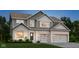 Charming two-story home with a light brick facade, gray siding, and a well-manicured lawn at 4355 Persian St, Greenwood, IN 46143