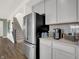 Modern kitchen showcasing stainless steel refrigerator, countertops, and convenient stairs at 4355 Persian St, Greenwood, IN 46143