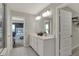Bright bathroom featuring double sinks and an open doorway to the main bedroom and closet at 4372 Persian St, Greenwood, IN 46143