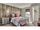 Bedroom showcasing rustic wood accent wall and unique side tables at 4372 Persian St, Greenwood, IN 46143