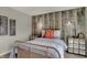 Bedroom featuring a wood accent wall, a red Manchester United throw pillow, and a gray duvet at 4372 Persian St, Greenwood, IN 46143