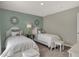 Inviting bedroom featuring twin beds, stylish accents, and soft, white bedding at 4372 Persian St, Greenwood, IN 46143