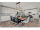 Contemporary dining area featuring modern light fixture and an adjacent open kitchen at 4372 Persian St, Greenwood, IN 46143