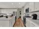 Bright kitchen with an island, stainless steel appliances, and an open floor plan to living space at 4372 Persian St, Greenwood, IN 46143