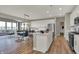 Open-concept kitchen featuring an island with seating and easy access to the dining and living areas at 4372 Persian St, Greenwood, IN 46143