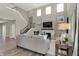 Bright living room featuring a fireplace, staircase, two-story ceiling and wood-look flooring at 4372 Persian St, Greenwood, IN 46143