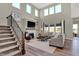 Bright living room with high windows, a fireplace, and comfortable seating at 4372 Persian St, Greenwood, IN 46143