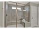 Modern shower with bench seating, glass doors, and neutral tile at 4372 Persian St, Greenwood, IN 46143