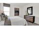 Well-lit bedroom featuring a dresser, mirror, and neutral color scheme at 4400 Persian St, Greenwood, IN 46143
