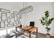 Home office with a modern light fixture, shiplap walls, and a desk with a plant at 4400 Persian St, Greenwood, IN 46143