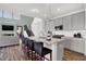 Well-appointed kitchen island featuring sleek gray cabinets, a breakfast bar, and seamless access to living areas at 4400 Persian St, Greenwood, IN 46143
