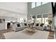Inviting living room featuring a soaring ceiling, large windows, and an open layout to the modern kitchen at 4400 Persian St, Greenwood, IN 46143