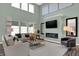 Bright living room with high ceilings, a modern fireplace, large windows, and comfortable seating at 4400 Persian St, Greenwood, IN 46143