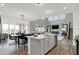 The kitchen island opens into a living room with modern decor, including a fireplace and staircase at 4400 Persian St, Greenwood, IN 46143