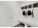Functional mud room with built-in bench, coat hooks, and humorous wall decor at 4400 Persian St, Greenwood, IN 46143