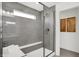 Elegant walk-in shower with sleek tile, glass enclosure, and a convenient built-in bench at 4400 Persian St, Greenwood, IN 46143