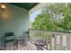 Balcony with chairs and table overlooking leafy green trees at 455 S Pine St # 4, Indianapolis, IN 46203