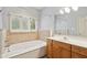Bright bathroom with a garden tub, window and double vanity at 455 S Pine St # 4, Indianapolis, IN 46203