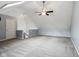 Spacious bonus room with vaulted ceilings, skylight, ceiling fan and neutral carpet at 455 S Pine St # 4, Indianapolis, IN 46203