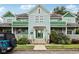 Charming two-story home with a light blue exterior, green accents, covered porches, and landscaped yard at 455 S Pine St # 4, Indianapolis, IN 46203