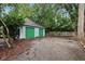 Two-car detached garage with a light blue exterior and vibrant green doors, set on a paved driveway at 455 S Pine St # 4, Indianapolis, IN 46203