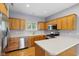 This kitchen features wooden cabinets, stainless steel appliances, and light countertops at 455 S Pine St # 4, Indianapolis, IN 46203
