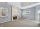 Spacious living room featuring a fireplace, gray carpet, and natural light from multiple windows at 455 S Pine St # 4, Indianapolis, IN 46203