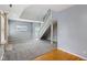 Bright, open living space with staircase, fireplace, gray carpet, and hardwood flooring at 455 S Pine St # 4, Indianapolis, IN 46203