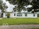 Charming single-story home with white siding, blue shutters, and manicured front lawn at 4617 Autumn Ridge Dr, Columbus, IN 47203