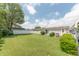 Expansive backyard featuring a lush lawn, mature trees, and white privacy fence with a single-story house in the background at 4641 Autumn Ridge Dr, Columbus, IN 47203