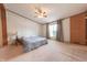 Comfortable bedroom bathed in natural light from the window, with a ceiling fan and neutral decor at 4641 Autumn Ridge Dr, Columbus, IN 47203