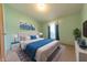 Inviting bedroom featuring a comfortable bed, stylish decor, and a large window for natural light at 4641 Autumn Ridge Dr, Columbus, IN 47203