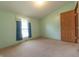 Bright bedroom with a window, carpet flooring, and fresh neutral decor for a tranquil retreat at 4641 Autumn Ridge Dr, Columbus, IN 47203