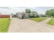 Charming single-story home with a long driveway, well-manicured lawn, tidy landscaping, and a covered carport on the side at 4641 Autumn Ridge Dr, Columbus, IN 47203