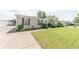 Single-story home with manicured lawn, tasteful landscaping, and carport at 4641 Autumn Ridge Dr, Columbus, IN 47203