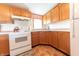 Kitchen featuring white appliances, wooden cabinets, and ample countertop space at 4641 Autumn Ridge Dr, Columbus, IN 47203