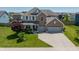 Beautiful two-story home featuring a brick facade, three-car garage, and well-maintained landscaping at 4863 Sherlock Dr, Westfield, IN 46062
