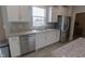 Well-lit kitchen featuring white cabinets, granite counters, stainless steel appliances, and undermount sink at 4863 Sherlock Dr, Westfield, IN 46062