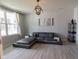 Modern living room featuring stylish gray sofa, large window, contemporary light fixture, and sleek shelving unit at 4863 Sherlock Dr, Westfield, IN 46062