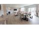 Open-concept living and dining area with modern furnishings, fireplace, dining table and sliding door to the outside at 4863 Sherlock Dr, Westfield, IN 46062