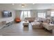 Bright living room with a large sectional sofa, modern decor, and plenty of natural light at 4863 Sherlock Dr, Westfield, IN 46062