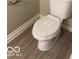Close-up of a newly installed toilet in a bathroom with modern flooring and fresh paint, ready for use at 4943 S State Ave, Indianapolis, IN 46227