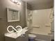 Bathroom with shower over tub, white tiles and ample storage, combining functionality with a clean aesthetic at 4943 S State Ave, Indianapolis, IN 46227