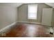 Small bedroom with a window and door and poor flooring at 4943 S State Ave, Indianapolis, IN 46227