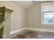 Small bedroom with a window and poor flooring at 4943 S State Ave, Indianapolis, IN 46227