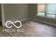 Bedroom featuring hardwood floors and a window providing natural light at 4943 S State Ave, Indianapolis, IN 46227