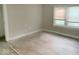 Bright bedroom featuring light walls, trim, window, and a light-toned hardwood floor waiting for carpet at 4943 S State Ave, Indianapolis, IN 46227