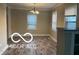 Dining room with wood floors, neutral colors, and natural light from two windows creating a warm ambiance at 4943 S State Ave, Indianapolis, IN 46227