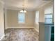Light filled dining room with modern light fixture, large windows, and new floors at 4943 S State Ave, Indianapolis, IN 46227