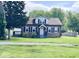 Charming two-story home featuring a well-maintained lawn and classic architectural details at 4943 S State Ave, Indianapolis, IN 46227